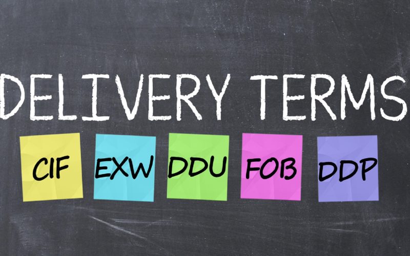 Delivery terms with adhesive notes on a blackboard